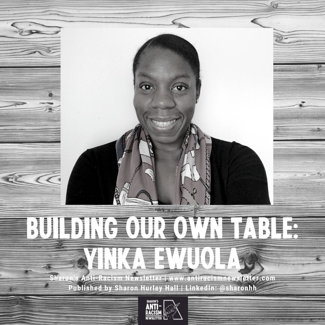 Building Our Own Table: Yinka Ewuola, Picture of Yinka Ewuola against a wooden table background