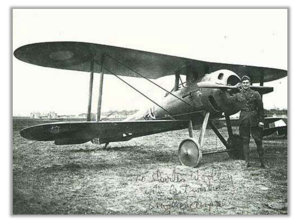 Douglas Campbell stands at the nose of his biplane.