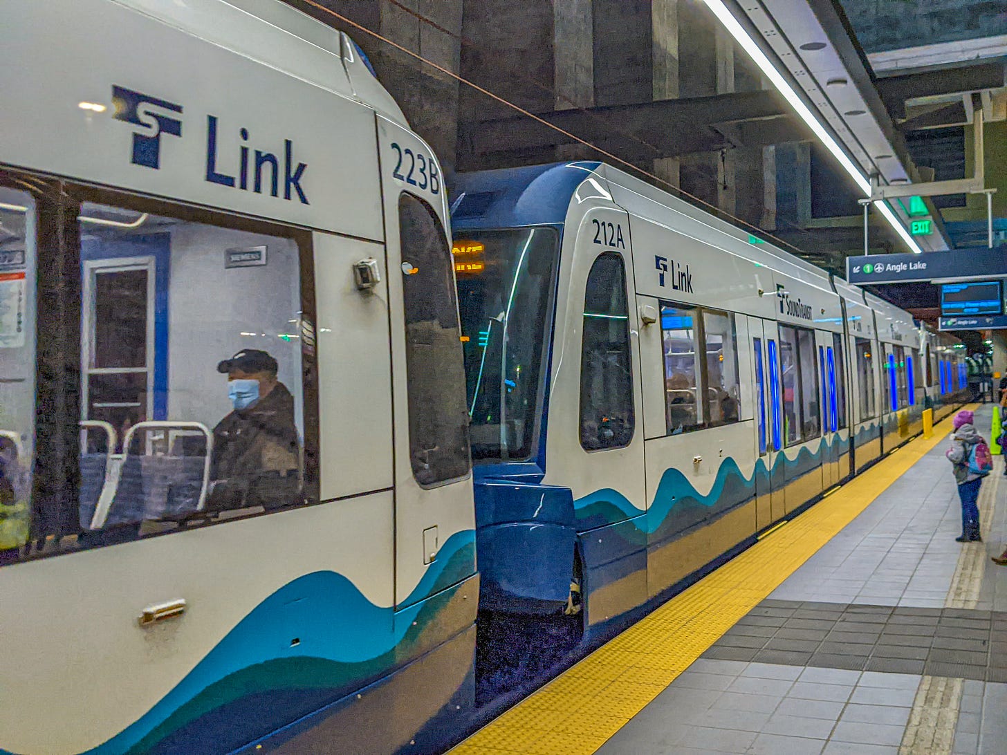 Two light rail cars stopped at Seattle's Roosevelt Station.