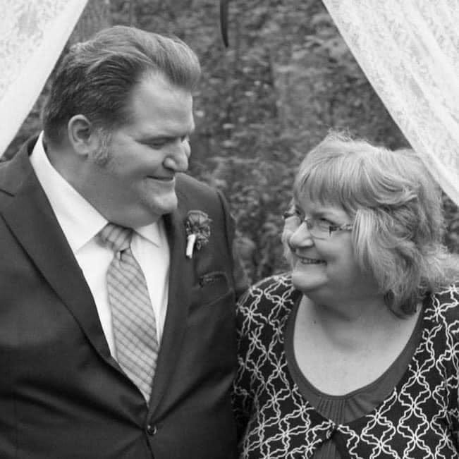The author and his mother smiling at each other at his wedding.