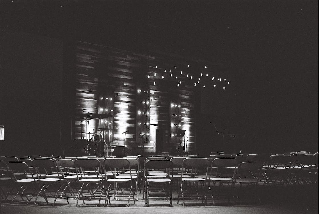 Free Grayscale Photography Of Chairs In An Auditorium Stock Photo