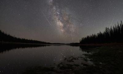Milky Way and Reflection over an Alpine Lake with 3 Meteors in the Sky Photo Credit: j2chav (iStock).