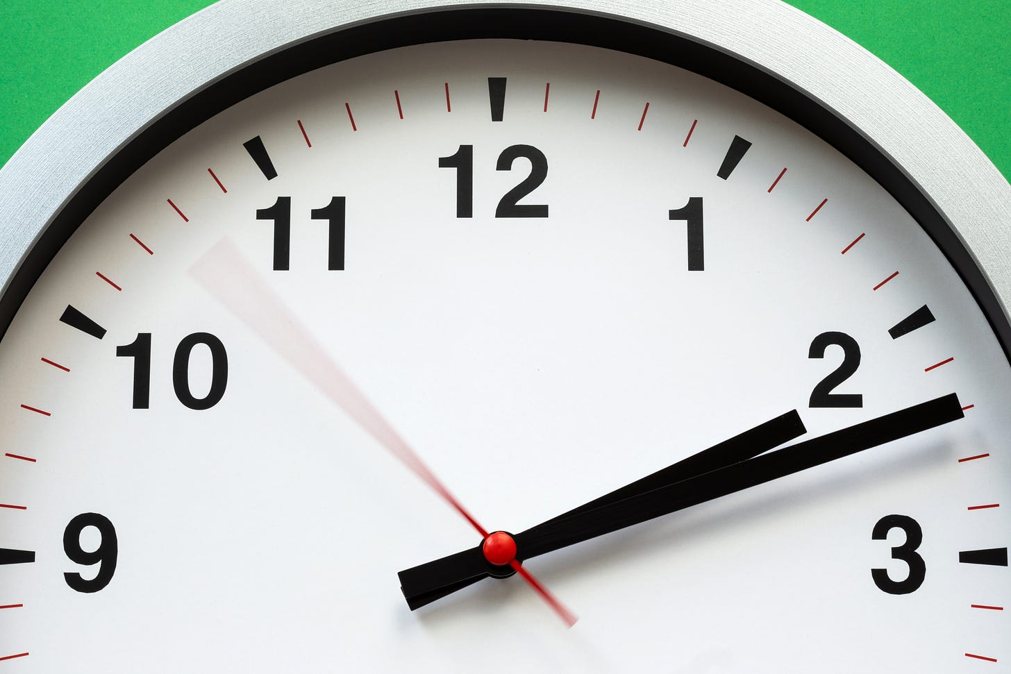 Partial white clockface on a green background