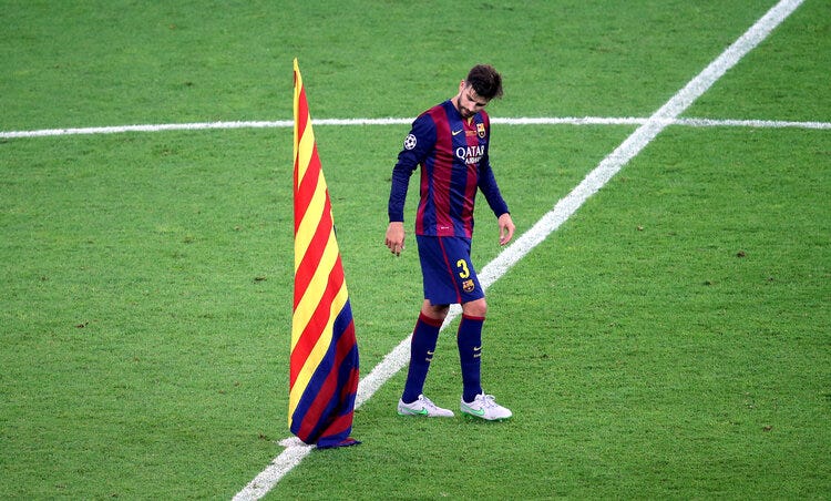 Symbolic: Gerard Piqué plants the Catalan flag in the centre of the pitch after the 2015 UEFA Champions League final in Berlin