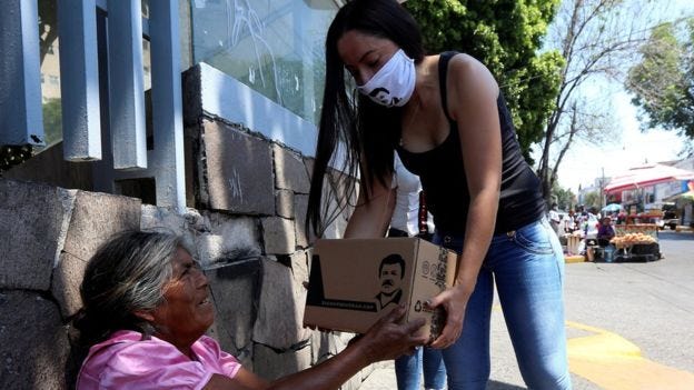 Woman hands out food parcels on behalf of the clothing company owned by El Chapo Guzman's daughter