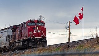 File:Canadian Pacific Railway locomotive passing a Canadian flag.jpg