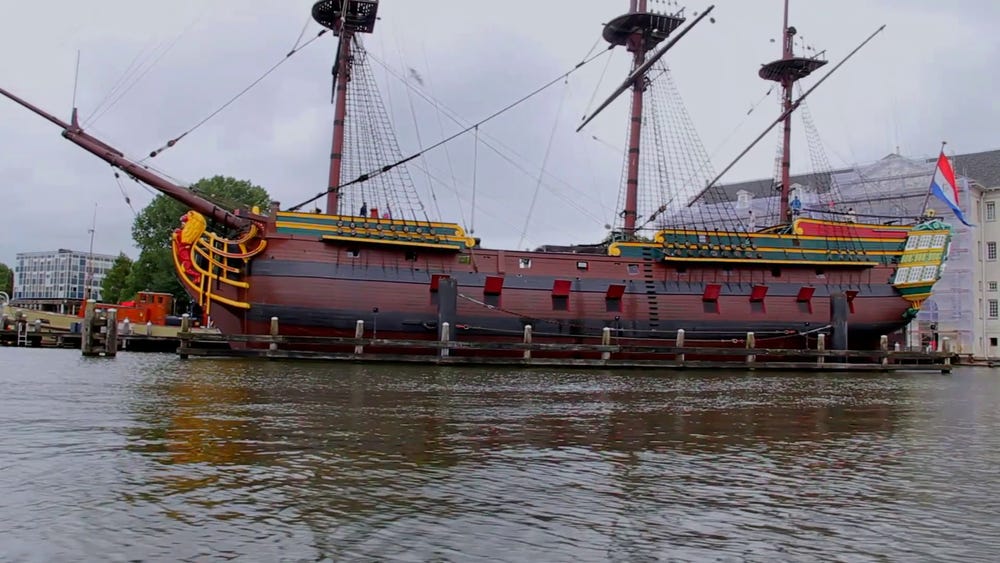 A replica 1700s trading ship, used for trading by a private corporation. The red flaps are not decorative: as in nature &amp; Eve Online, “Red Means Dead”