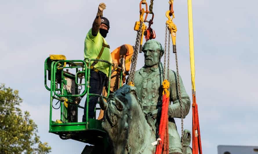 Workers remove the statue of the Confederate general Robert E. Lee in Market Street Park in Charlottesville, Virginia, on Saturday.