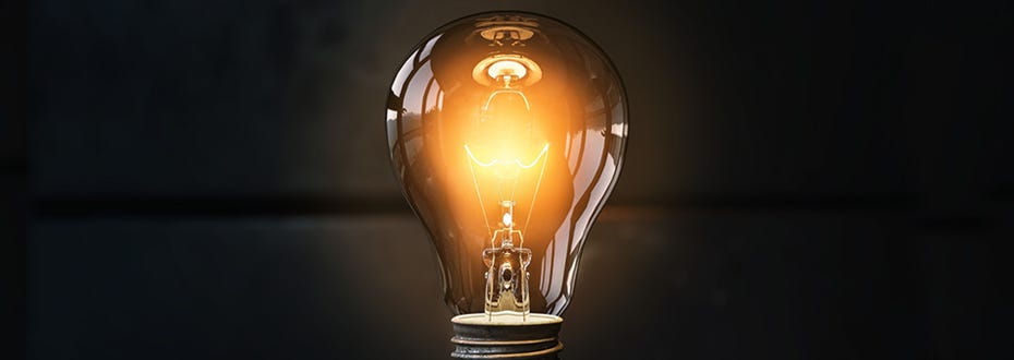 An image of a lightbulb burning bright against a dark background.