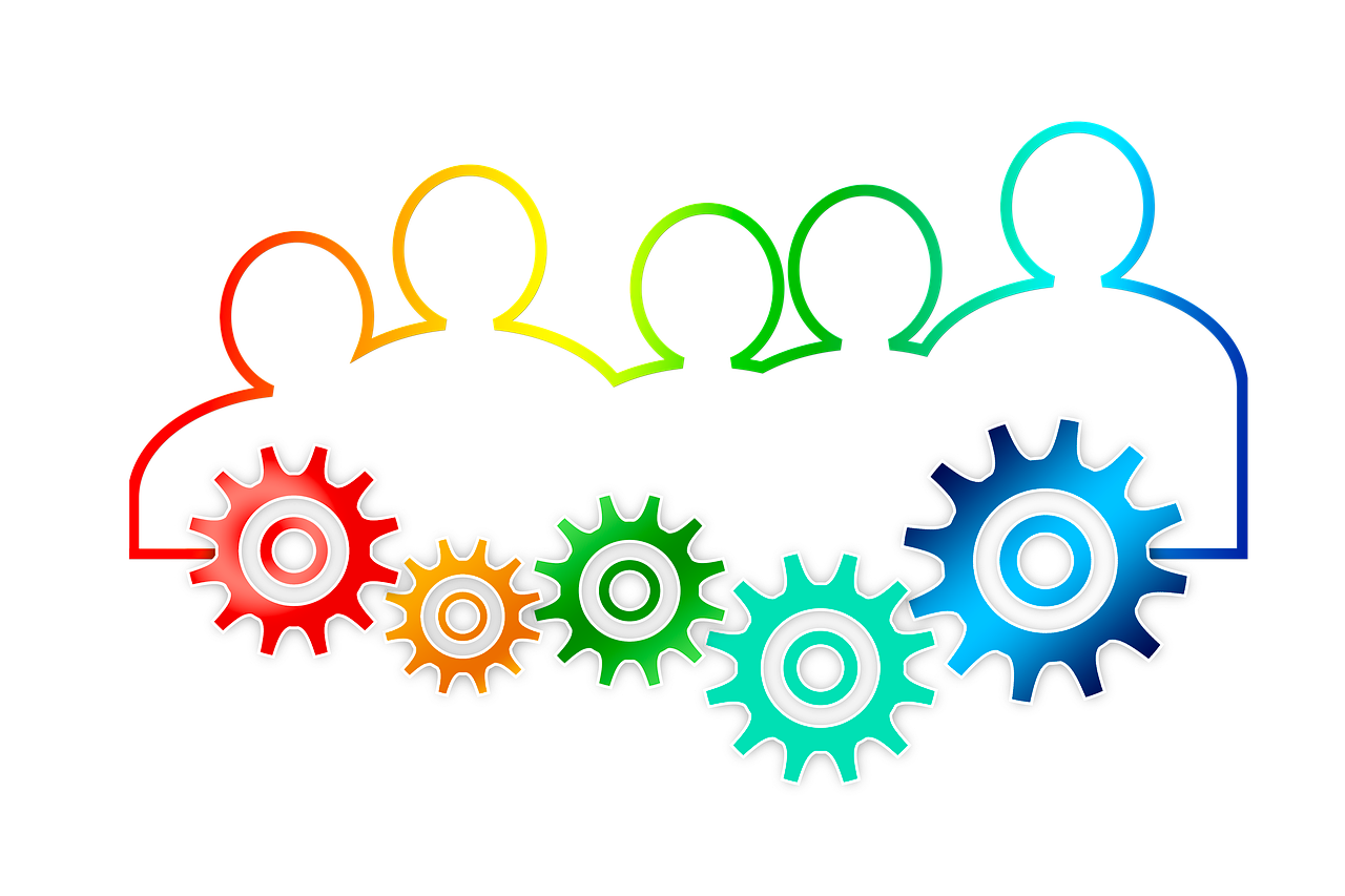 silhouettes of people head/shoulders with colored gears in front, all in rainbow outline