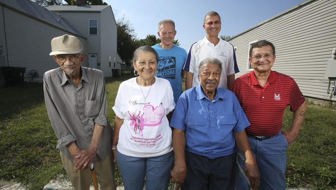 The Guess siblings, from left to right: William Guess, 86, Shirley Crowe, 78, Emory Guess, 80, Carey Guess, 70, Wellington Guess, 82, (in front with blue shirt) and Harold Guess, 83. They belong to a family that has roots in the Smoketown neighborhood that date back to the 1920s. They are standing in front of the lot where the home they lived in for decades burned down in 2011.    
Oct. 6, 2016