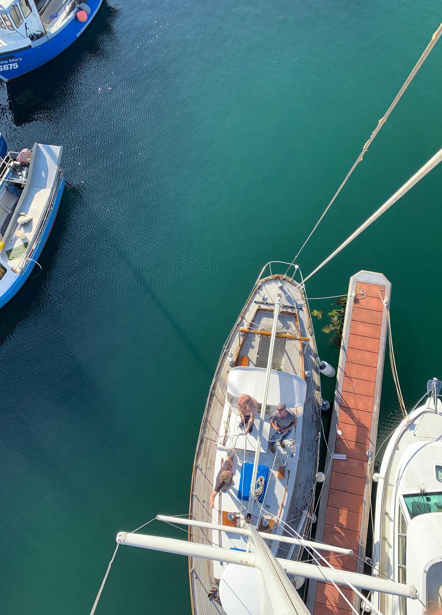 looking down from the top of a sailboat mast