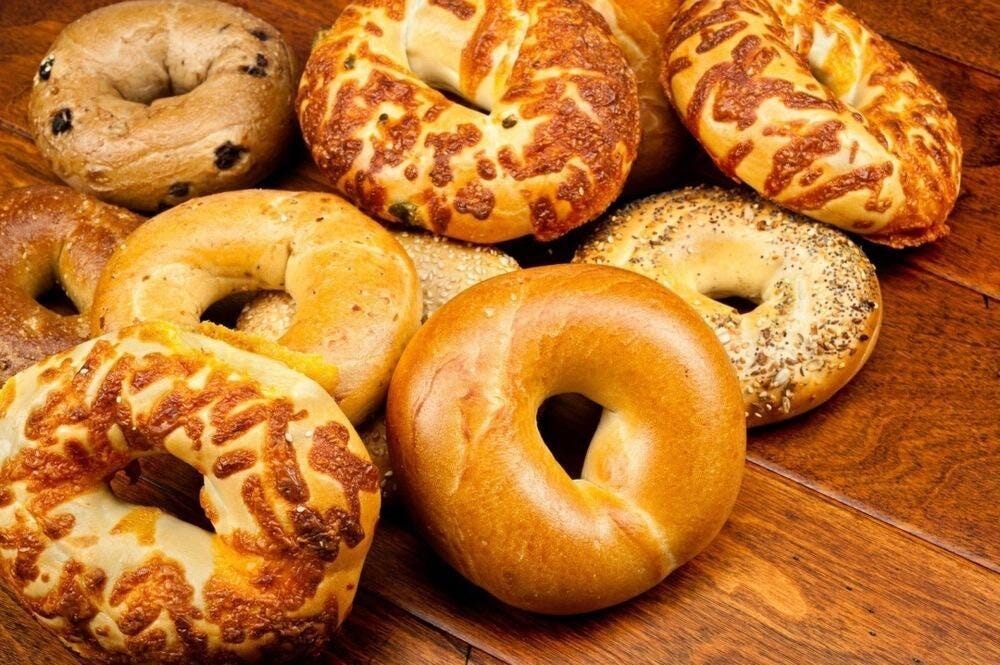 A mixed selection of bagels on a wooden table
