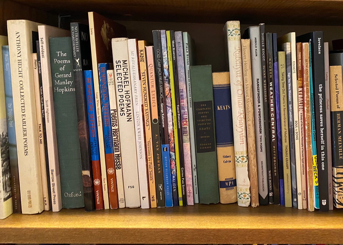 A picture of several poetry books on a shelf