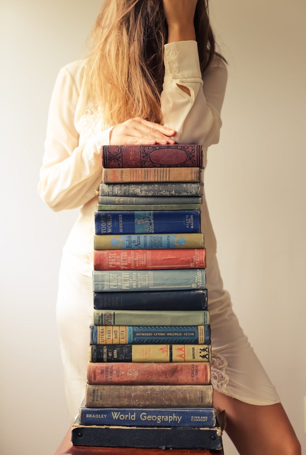 woman in white long sleeve shirt reading books