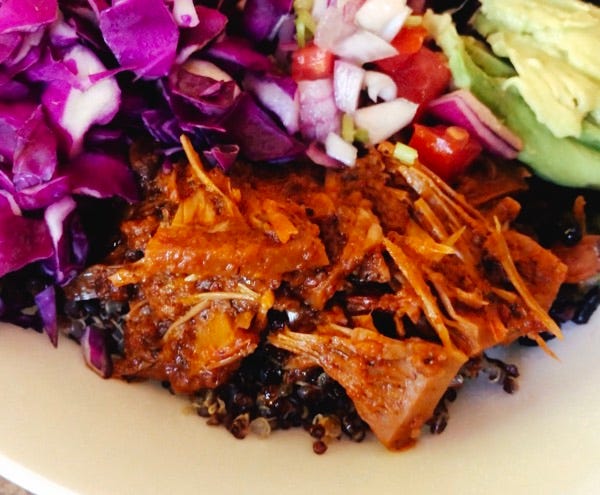 cooked luluchi chilorio vegan on a plate with other foods.