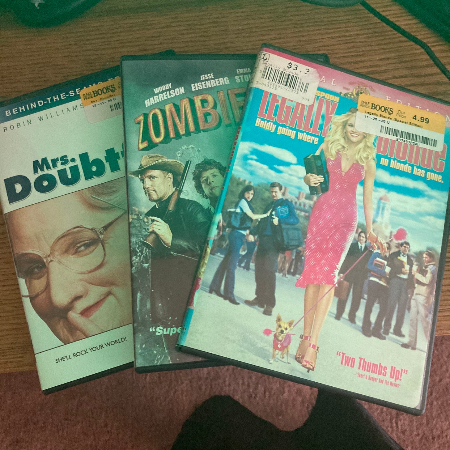 Image Description: Three DVD boxes lay on top of each other, fanned out so the covers are partially visible. These movies from left to right are Mrs. Doubtfire, Zombieland, and Legally Blonde.