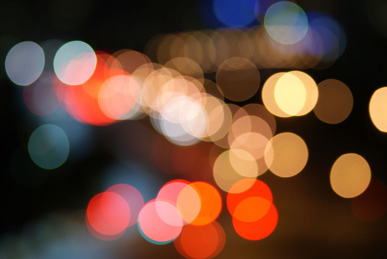 Photograph with blurred vision of colourful dots, apparently bokeh balls