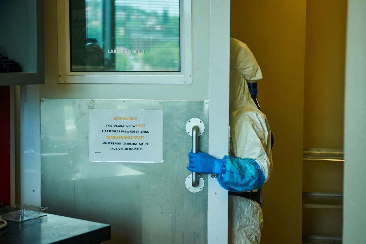 A technician wearing a full-body protection suit enters a biosafety level 3 Covid-19 research laboratory at the African Health Research Institute in Durban, South Africa.