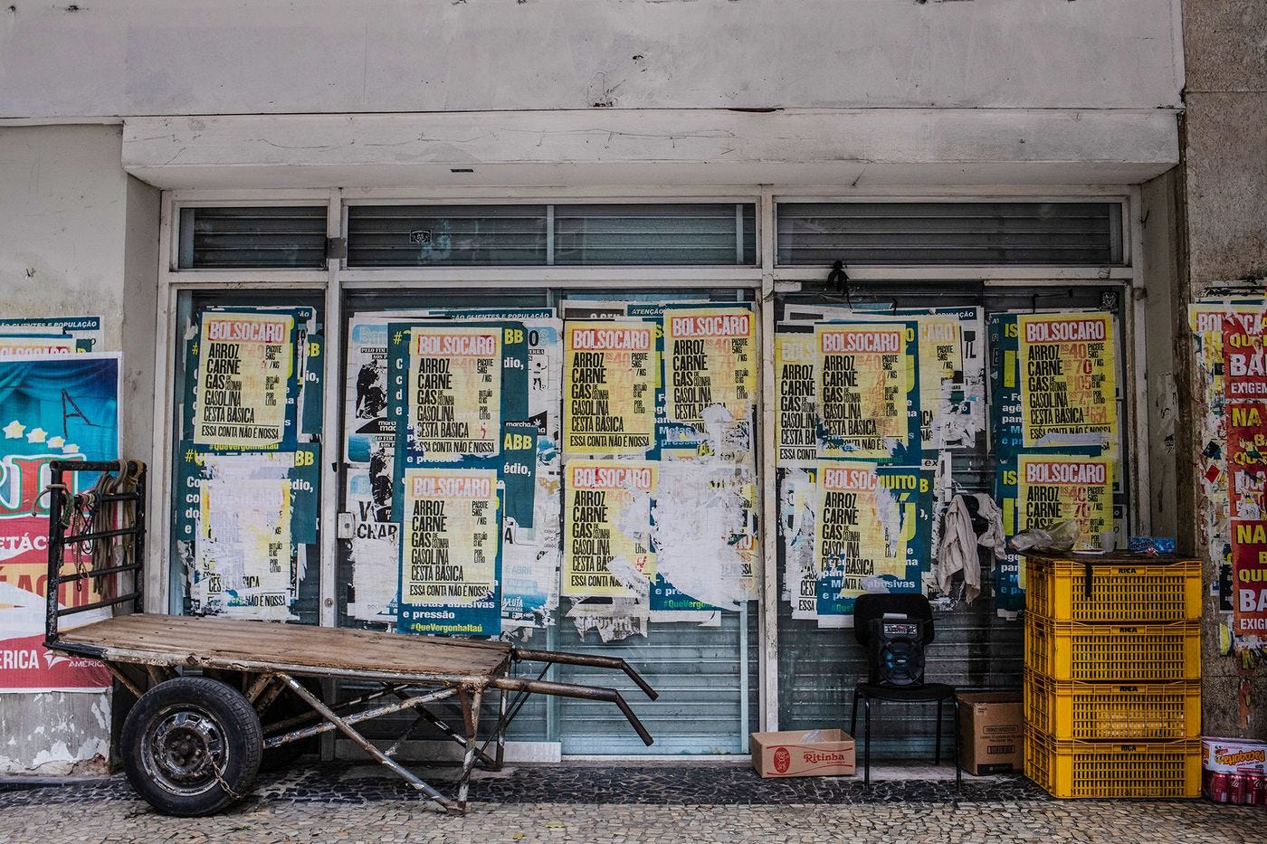 Signs plastered on buildings in downtown Rio de Janeiro blame President Jair Bolsonaro for surging food prices.&nbsp;