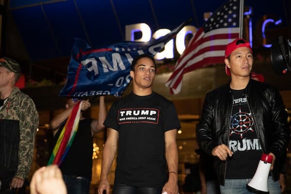 Christian Walker, center, at a Los Angeles event in support of Donald Trump in 2020. He has emerged as a conservative social media star who takes delight in provoking the left, and defending Mr. Trump’s MAGA movement.