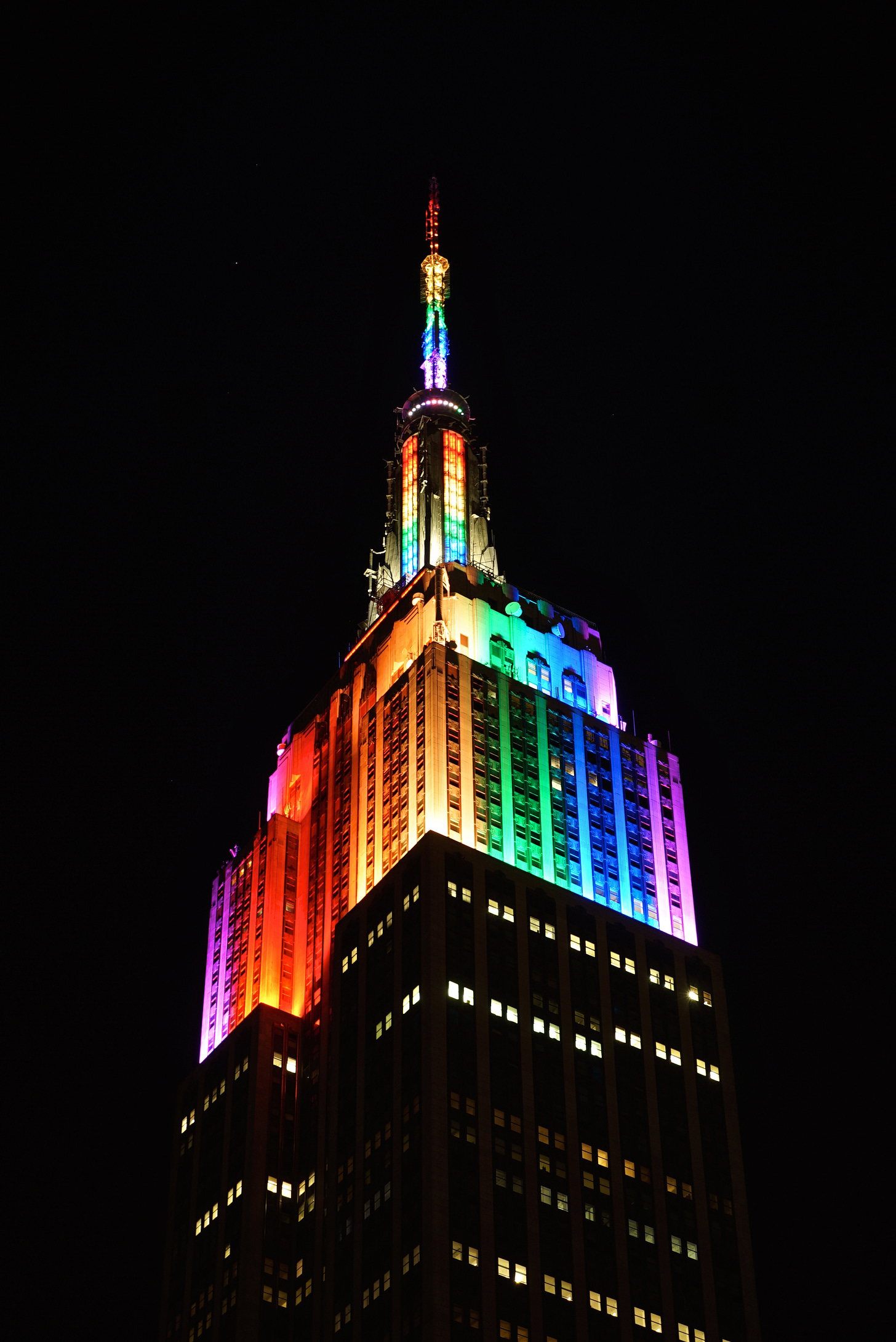 Photo of Empire State Building at night lit in Rainbow lights