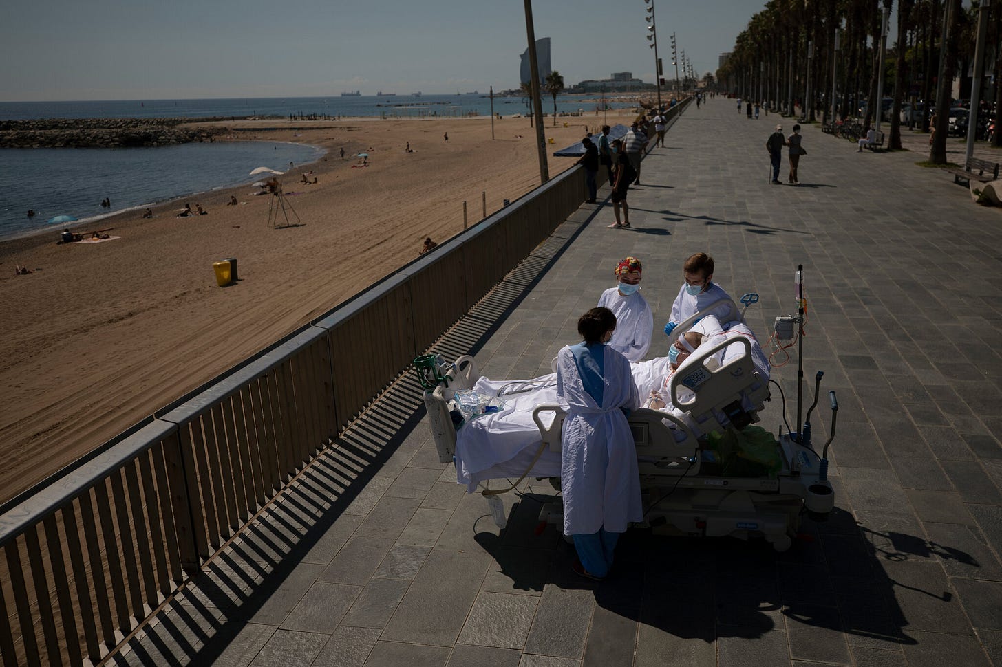 Barcelona, Sept. 4 Francisco España, 60, a Covid-19 patient who had spent weeks in an intensive care unit, was brought out of the hospital by medical staff for a calming look at the sea. Emilio Morenatti/Associated Press