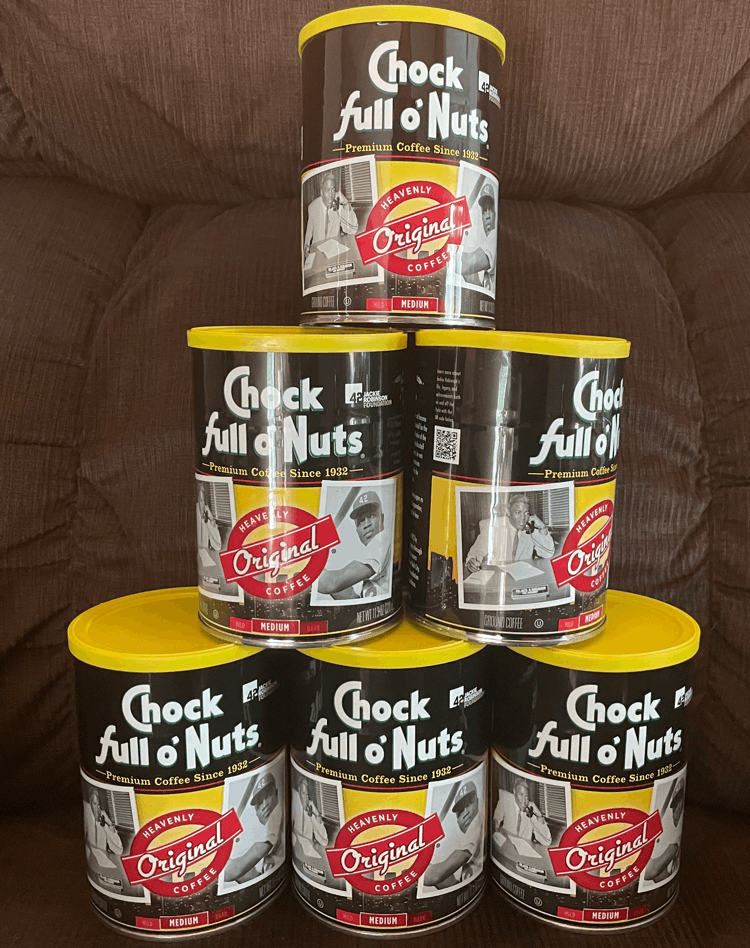 A photo of six cans of Chock full 'o Nuts coffee.