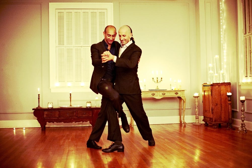Two men smiling and dancing
