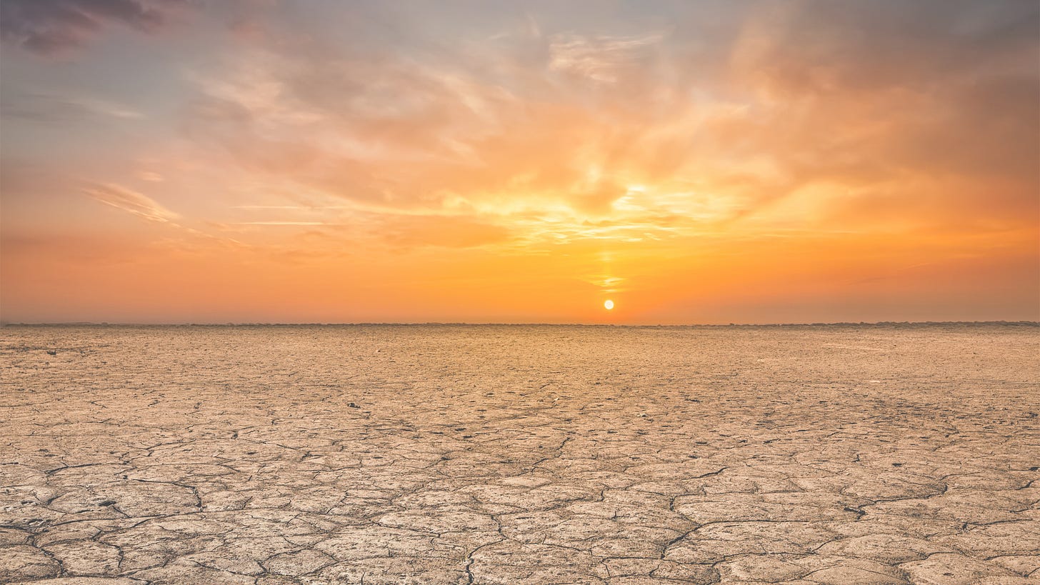 sunset over a vast dry land