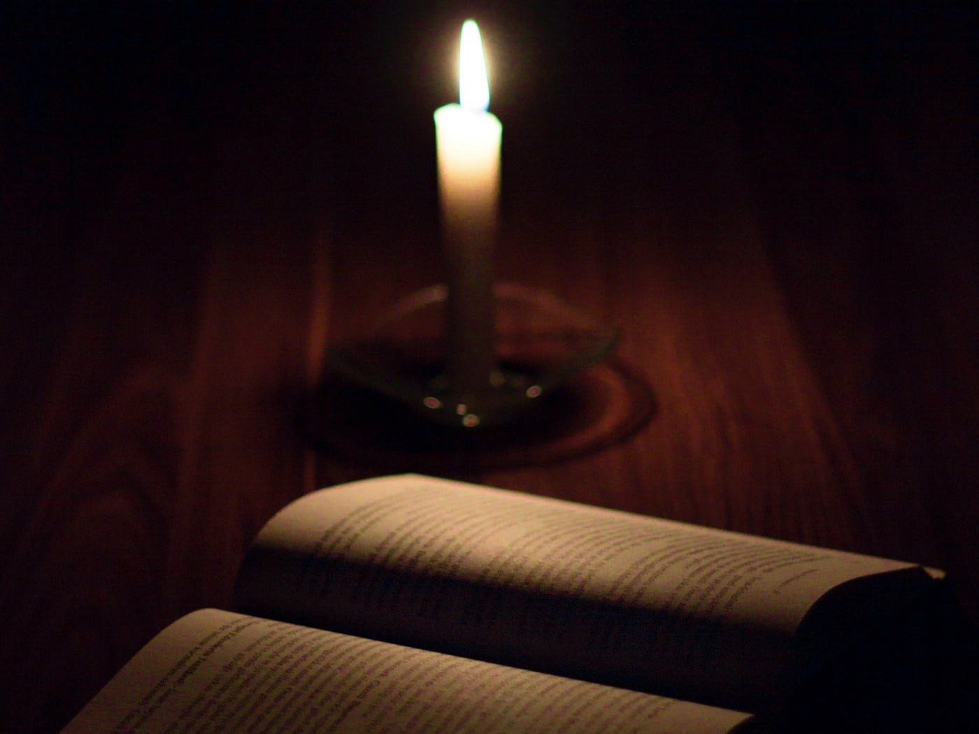 A photograph of a book and candle.