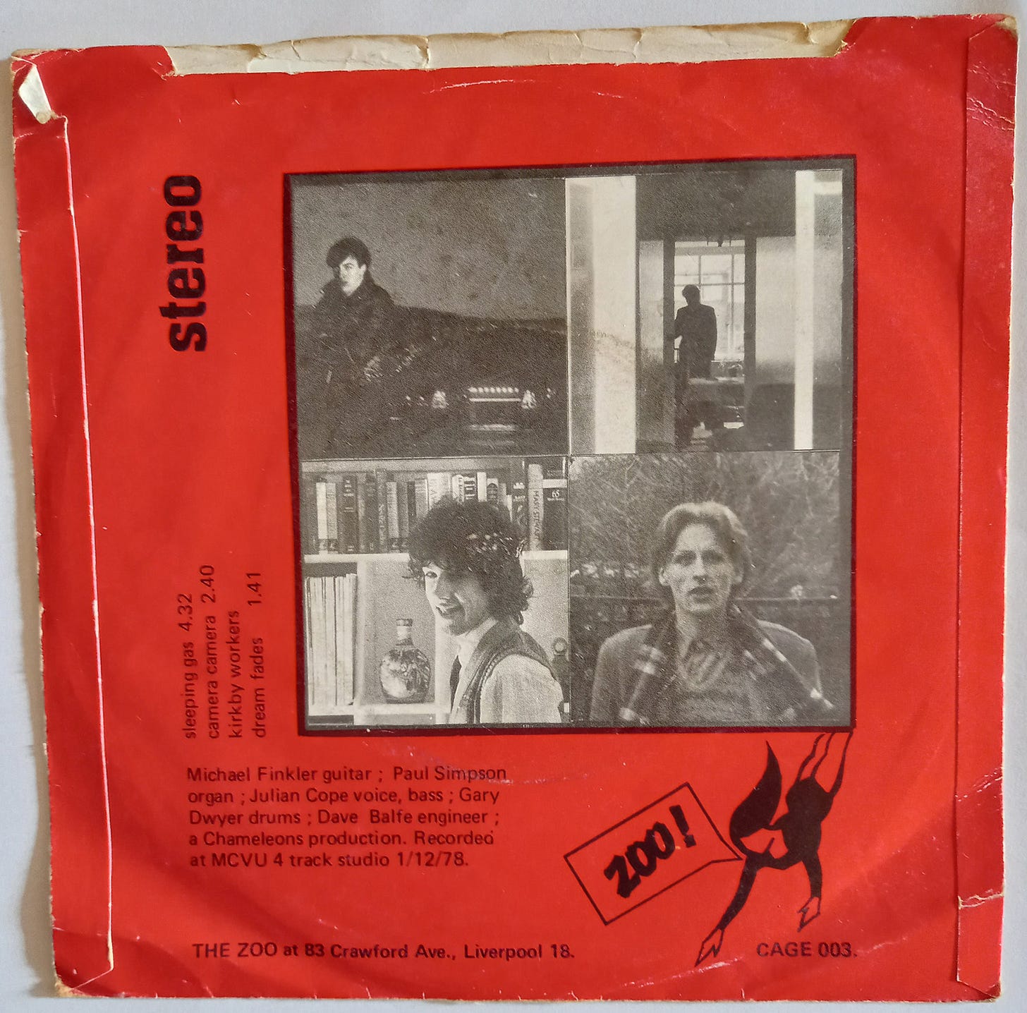 The back of the picture sleeve of the Sleeping Gas single. It's red, with photos of the four band members in black and white.