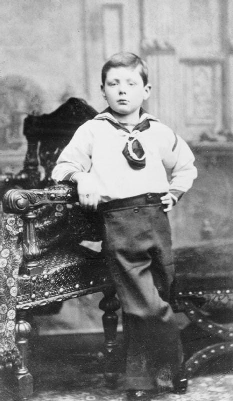 A 6-year-old Winston Churchill is depicted (1881). He is leaning against a chair with one elbow and has his other hand on his hip. He looks serious and older than his years.