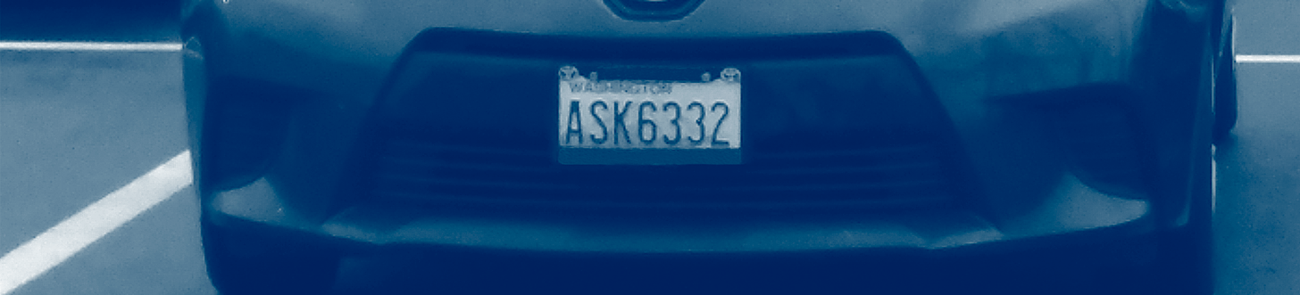 Front of single car in parking lot with ASK6332 license plate. Photo is a duotone of blues and greens.