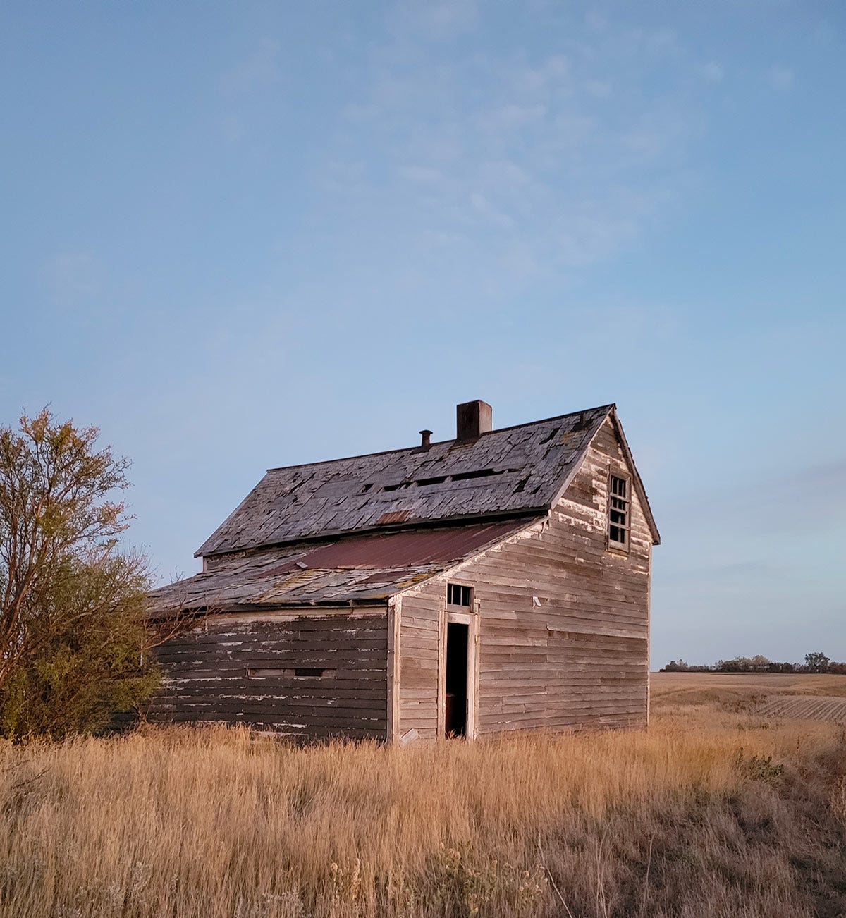 An old farmhouse on the prairie.