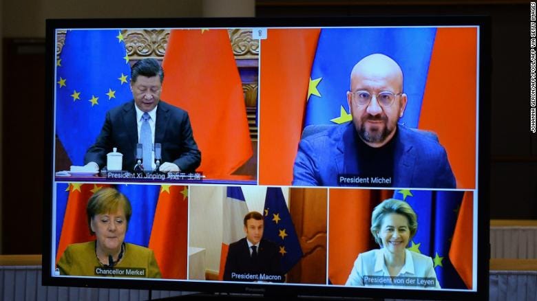 Chinese President Xi Jinping and European Union leaders seen on a screen during a video conference to approve an investment pact between China and the European Union on December 30, 2020 in Brussels, Belgium.