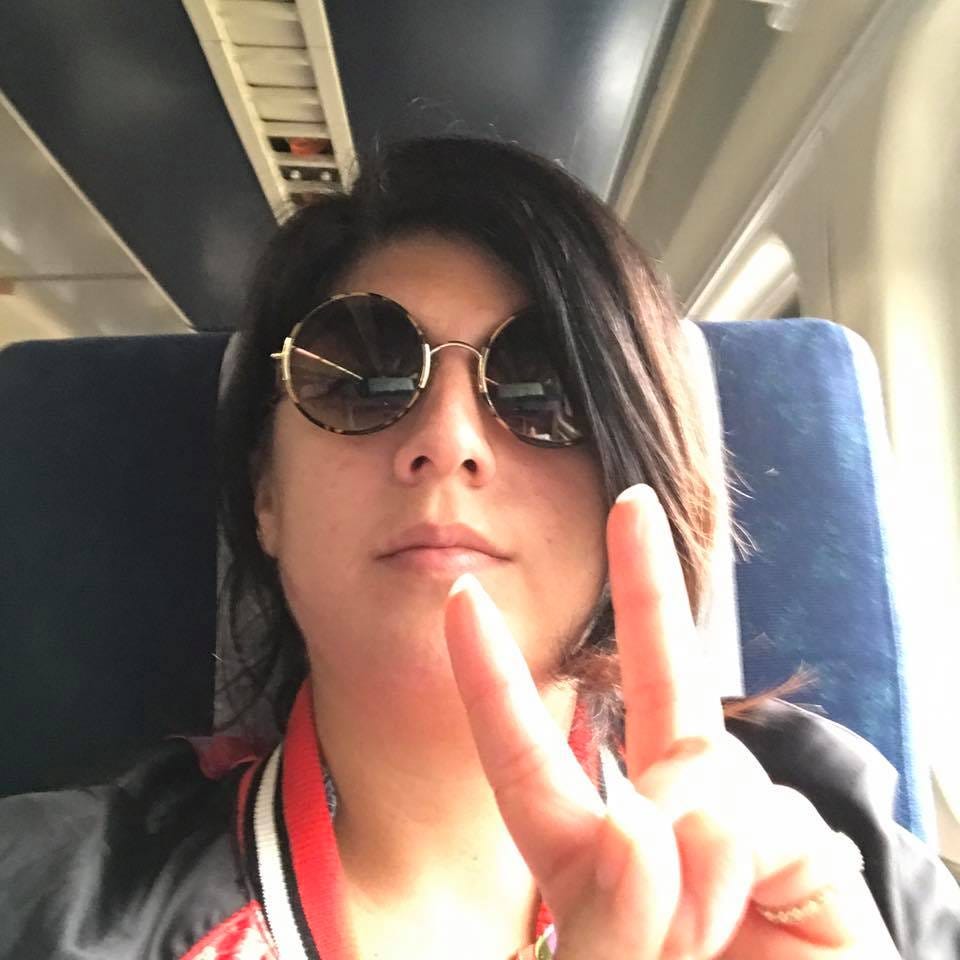 Photo of me, holding a peace sign with my fingers, on a train to Milwaukee