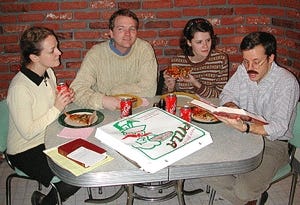 Larry Dunne (second from left) enjoys a Saturday-night "Pizza 'n' Prayer" party with his new friends.