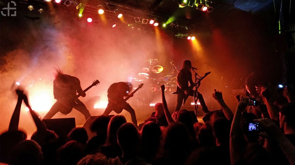 Metal band playing on stage in front of an audience