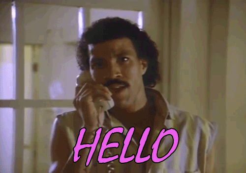 a gif of a black singer with a jheri curl saying "hello" into a phone.