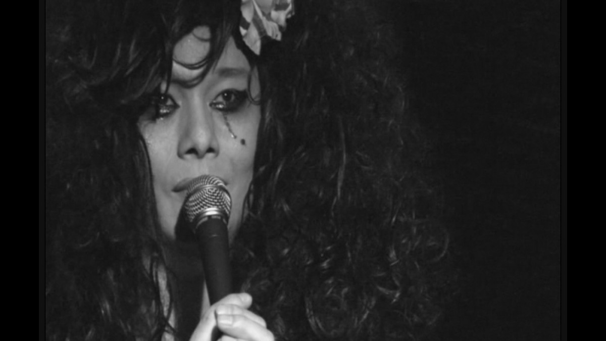 Bilan de Linphel cries as she holds the microphone close to her mouth Bilan de Linphel cries as she holds the microphone close to her mouth