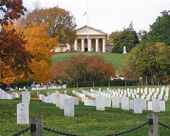 Arlington House sits on a knoll above tombstones at Arlington National Cemetery.