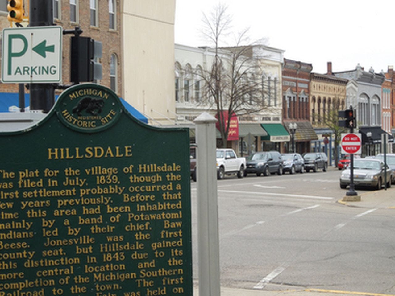 Green Hillsdale historical marker with downtown street in background