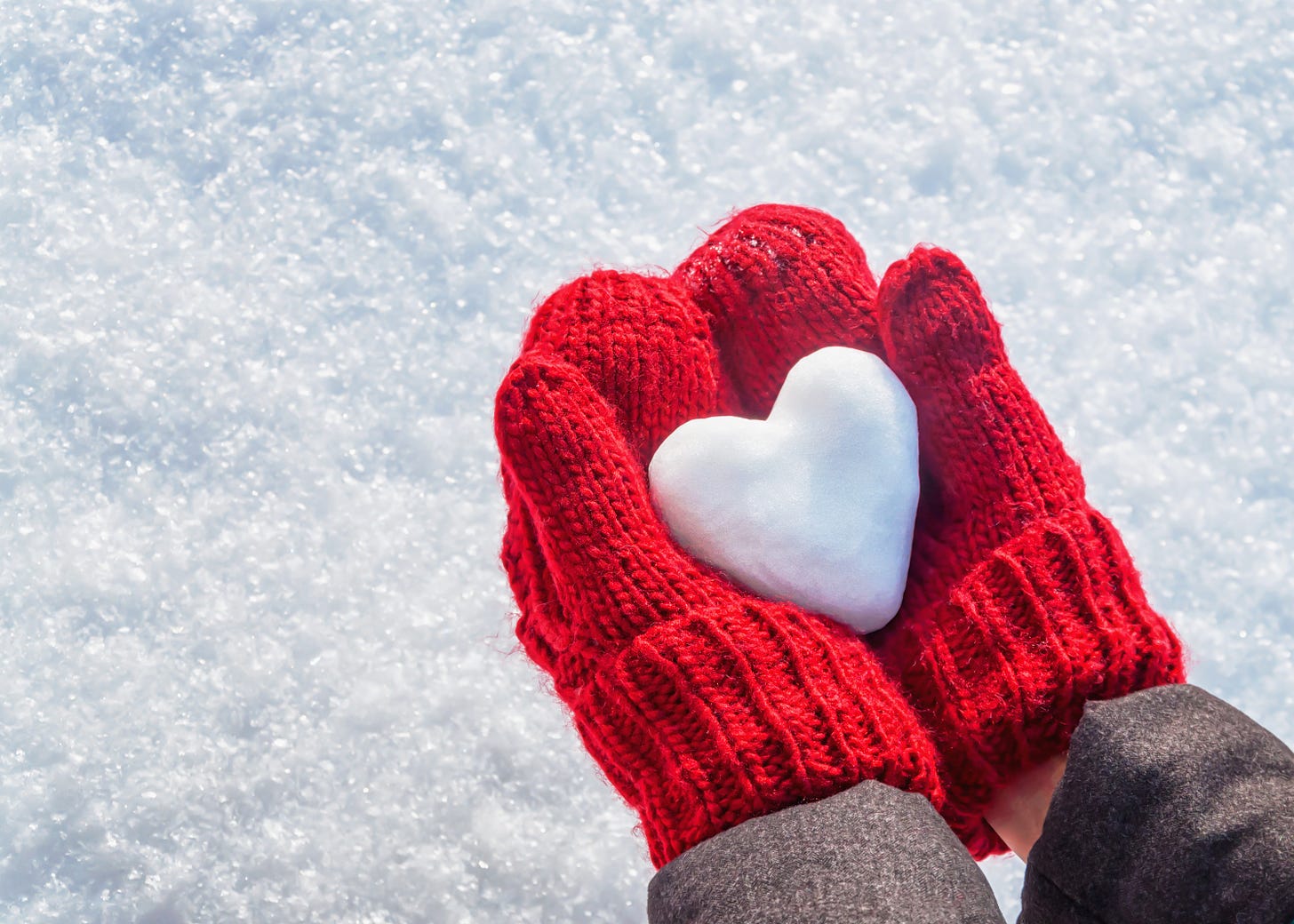 Female hands in knitted mittens with heart of snow in winter day. Love  concept. Valentine day background. - Columbia Center for the Arts