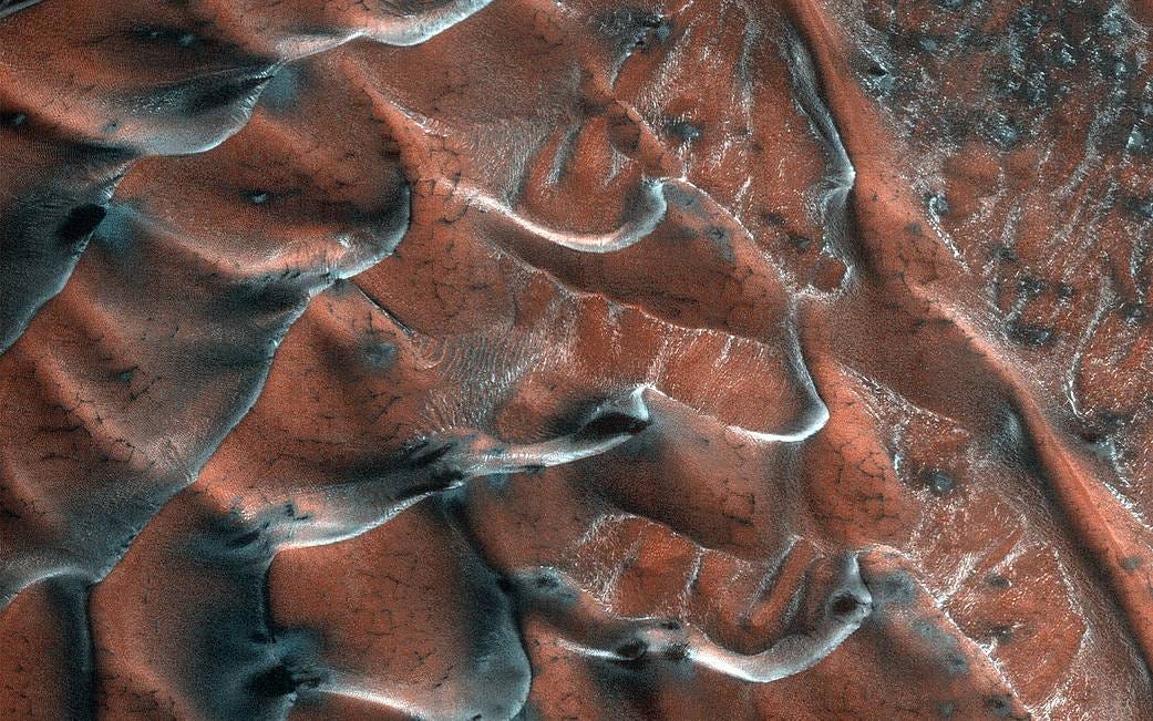 A field of sand dunes occupies this frosty 5-kilometer diameter crater in the high-latitudes of the northern plains of Mars.