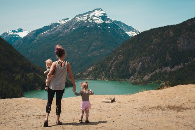 mother and children viewing scenic landscape
