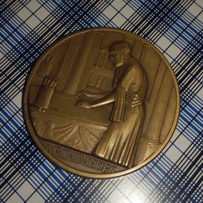 A medal, portraying an artistic representation of Archimedes.