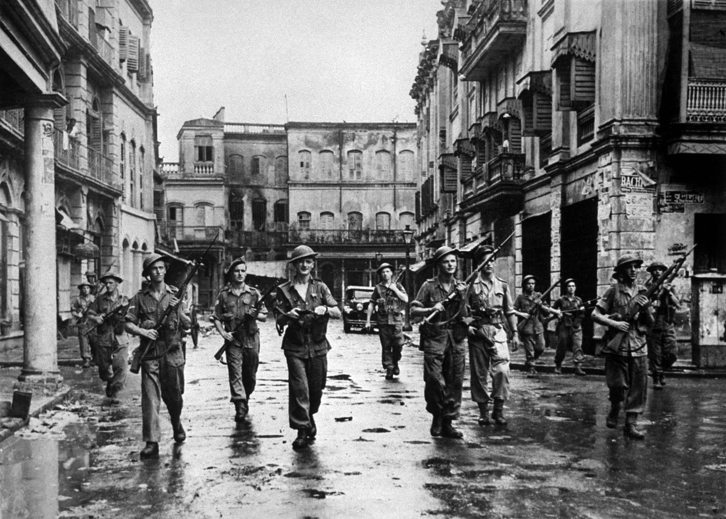 British troops in Calcutta, with rifles at the ready, clearing a street after Hindus and Muslims used firearms against each other