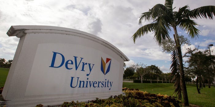 DeVry University sign next to a palm tree