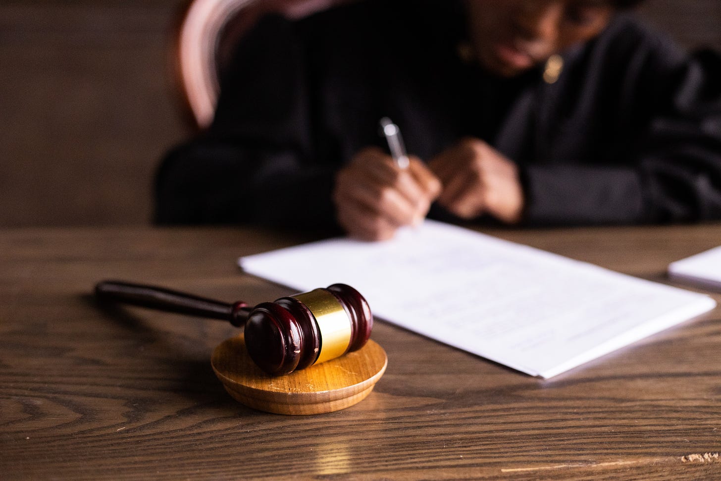 A judge's gavel lying on a desk.